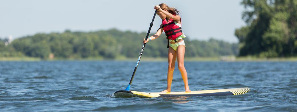 A Girl Scout Paddleboarding